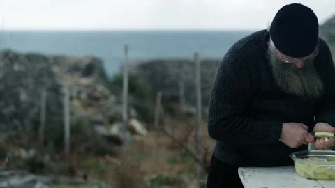 Orthodox monk peeling potatoes on Mount Athos Stock Footage 330197257
