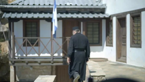 Orthodox monk walking down stone stairs at Mount Athos monastery Stock Footage 330196137