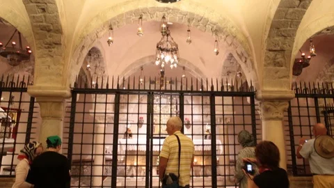Orthodox pilgrims pray in the cript of the Basilica of Saint Nicholas Video stock 129584146