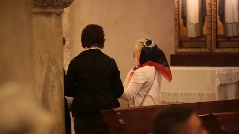 Orthodox pilgrims pray in the cript of the Basilica of Saint Nicholas Video stock 129584252