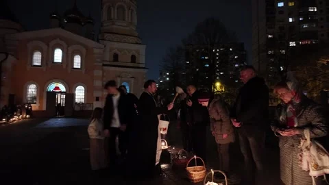 Orthodox Priest Blessing Easter Baskets With Holy Water At Night In Kyiv Stock Footage 332712304