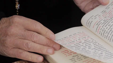 Orthodox priest leafing through the Bible Stock Footage 32197927