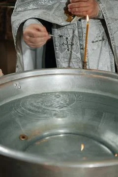 Orthodox priest performing the rite of anointing with oil during Stock-Fotos