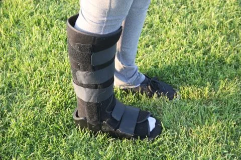 Orthopedic Walking Boot on Grass During Recovery Stock Photos