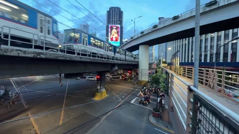 Ortigas Intersection Two MRT Trains Passing LED Billboard Twilight Wide 4K 60fps Stock Footage 338186703