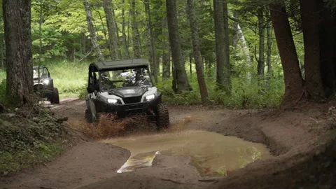 ORV riding through Mud Puddle Stock Footage 243206038