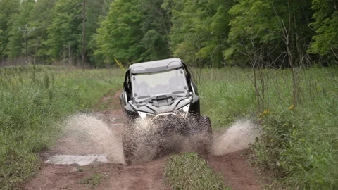 ORV Splashing Through Puddle on Trail Stock Footage 243205438