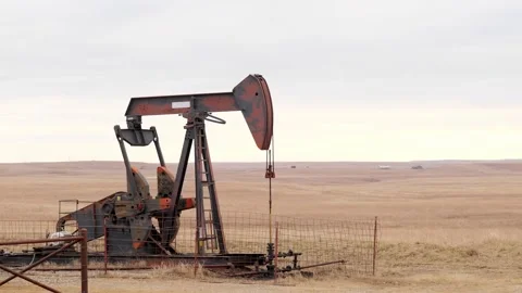 OSAGE CO., OK - 2 MAR 2020: Oil Well Pump Jack pumping crude oil. Stock Footage 142957686