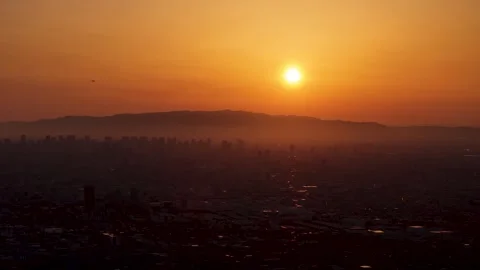 Osaka during sunset, plane flying over the city 스톡 동영상 341758081