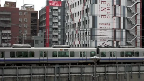 Osaka, Japan - 10/07/2023: Osaka Loop Line Train Going Past Shinsekai Stock Footage 257687937