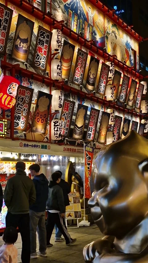 Osaka, Japan. Vertical View of Restaurant Exterior at Night With Sumo Wrestlers Stock Footage 337565257