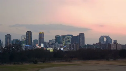 Osaka Subway train crossing bridge into Umeda city lights in Winter  스톡 동영상 72578853