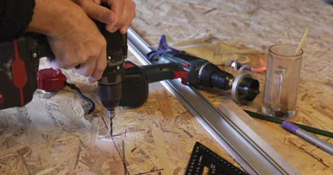 OSB panel hole drilling cordless drill closeup Stock Footage 329427443