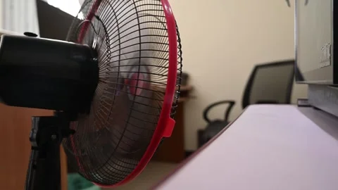 Oscillating Fan Cooling a Home Workspace on a Hot Day Stock Footage 346487035
