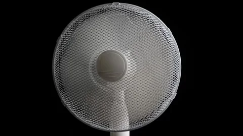 Oscillating floor fan on black background loop Stock Footage 341033990