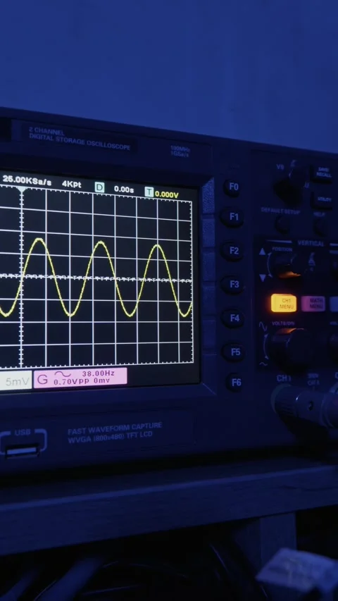 Oscilloscope Screen Displaying Sine Wave Signal in Dark Tech Laboratory Stock Footage 329922583
