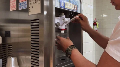 Ossining, NY, USA-March 27, 2017: Young Hispanic Man Uses Soft-Serve Ice Cream M Stock Footage 74701816