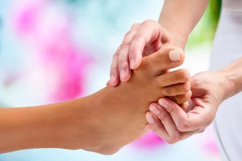Osteopath doing reflexology massage. Stock Photos