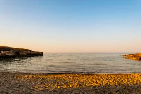 Ostuni beach at sunset between the wild nature of the coastal dunes nature park Stock Photos