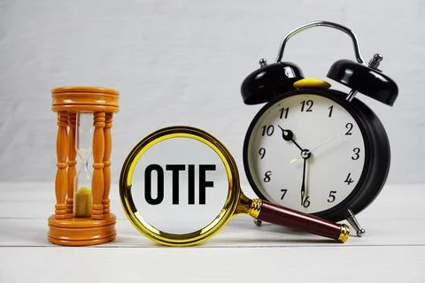 OTIF abbreviation of On Time In Full text with alarm clock on wooden backgrou Stock Photos