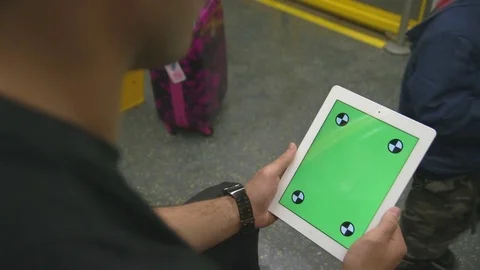 OTS male using iPad on train with green screen commuting to work Stock Footage 73721868