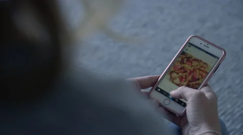 OTS shot of female using Instagram on an Iphone, in morning light. Stock Footage 65364575