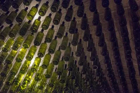Ottles hang from tac eikling as part of an art installation in a restaurant Stock Photos