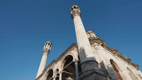 Ottoman Mosque Minarets Against Clear Blue Sky in Cinematic Low Angle View Vídeo Stock 335393150