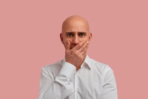 Ouch. I really said it. Close up portrait of bald man with bristle in white s Stock Photos