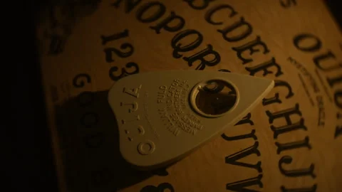 Ouija board planchette close-up Stock Footage 333691784