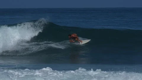 Oung surfer on a blue wave Stock Footage 295764894