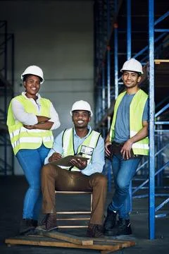 Our commitment puts us ahead of our competitors. Portrait of a group of builders Stock Photos