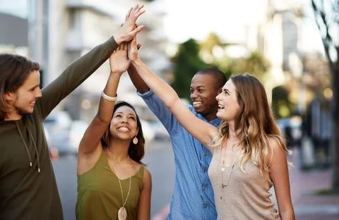 Our differences tie us together. a group of young friends giving each other a Stock Photos