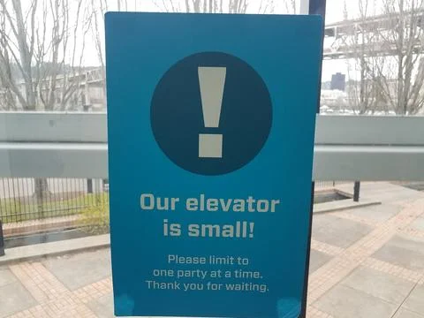 Our elevator is small sign covid warning sign Stock Photos