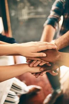 Our goal is a shared one. a group of businesspeople joining their hands together Stock Photos