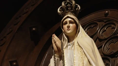 Our lady of fatima statue in crown with rosary in baroque wooden altar Stock Footage 313572547