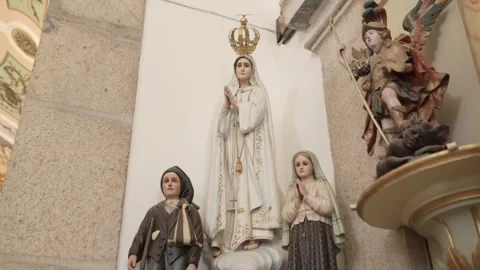 Our Lady of Fatima statue with shepherd children inside Portuguese church Stock Footage 344512226