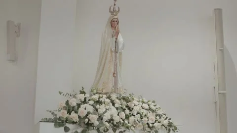 Our Lady of Fatima statue with white rose floral base in church Stock Footage 337781207
