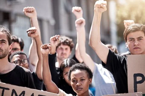 This is our moment. a group of young people during a protest rally with their Stock Photos