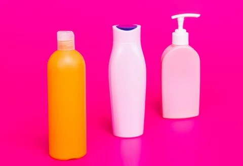 Our packaging solutions. Toiletry bottles pink background. Refillable bottles in Stock Photos