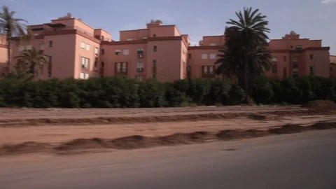Out of car window entering Marrakech with horse and cart, traffic and buildings Video stock 86519137