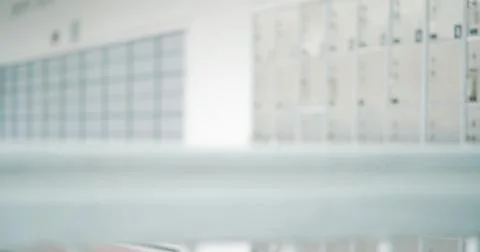 Out of focus background inside post office of p.o. boxes for mail security Photos