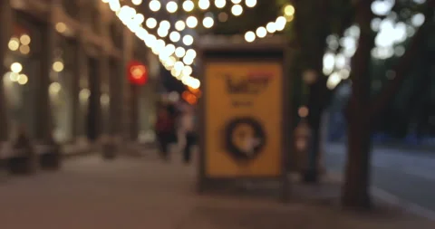 Out of focus background plate of city street from sidewalk at night. Blurry Stock Footage 131438063