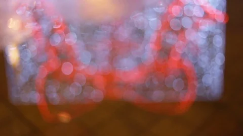 Out of focus, blurry. The reflection in the water a big red bow. Twinkle bulbs.  Stock Footage 83249605