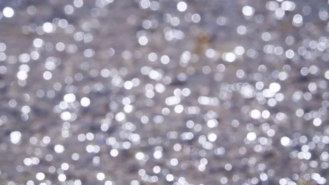 Out of focus bokeh dancing from light wind on the sea Vídeo Stock 76936117