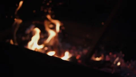 Out of focus bonfire with fire and coals burns on a dark background. With a Stock Footage 252872350