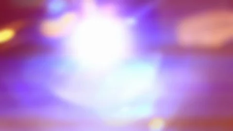 Out of Focus Bright Lights Shining into Lens with Flares - Shallow DOF Stock Footage 106855335