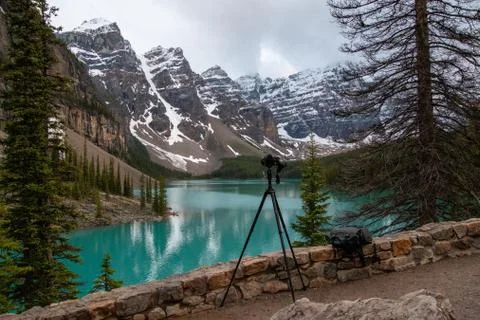 A out-of-focus camera in the foreground and Emerald lake in the background. Stock Photos