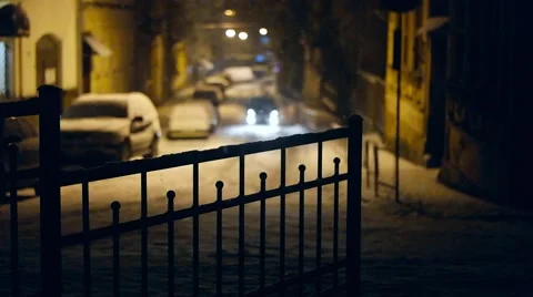 Out of focus car lights at snowing street in night. Slow motion Stock Footage 59702179