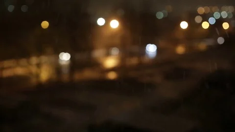 Out of focus car lights at snowing street in night. Stock Footage 71080409